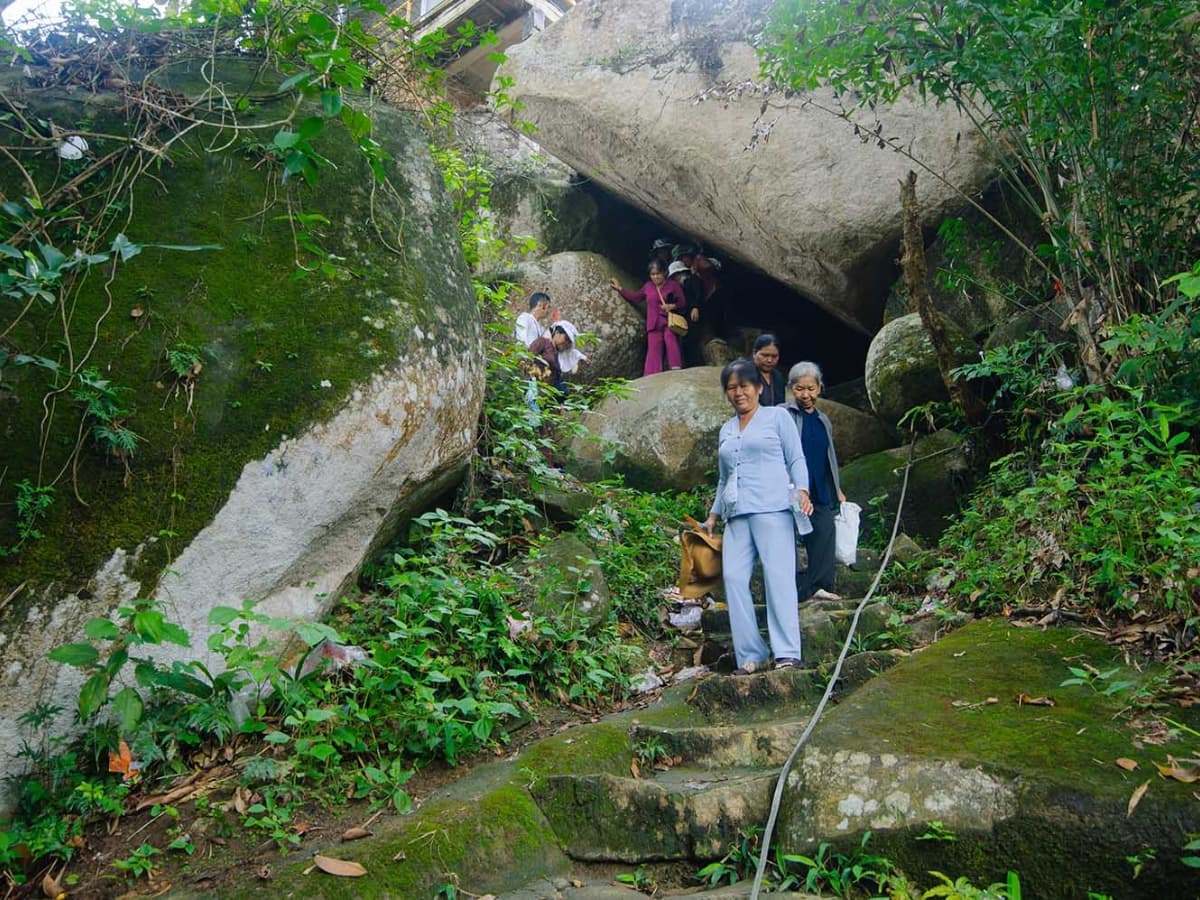 Du khách khám phá hang động tại núi Cấm.